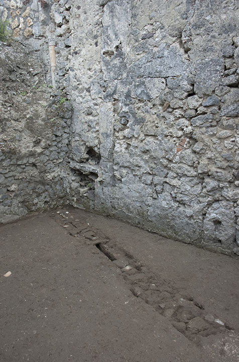 SE corner of room f, showing how the conduit probably meets up with the vertical terracotta pipe embedded in the S wall. 